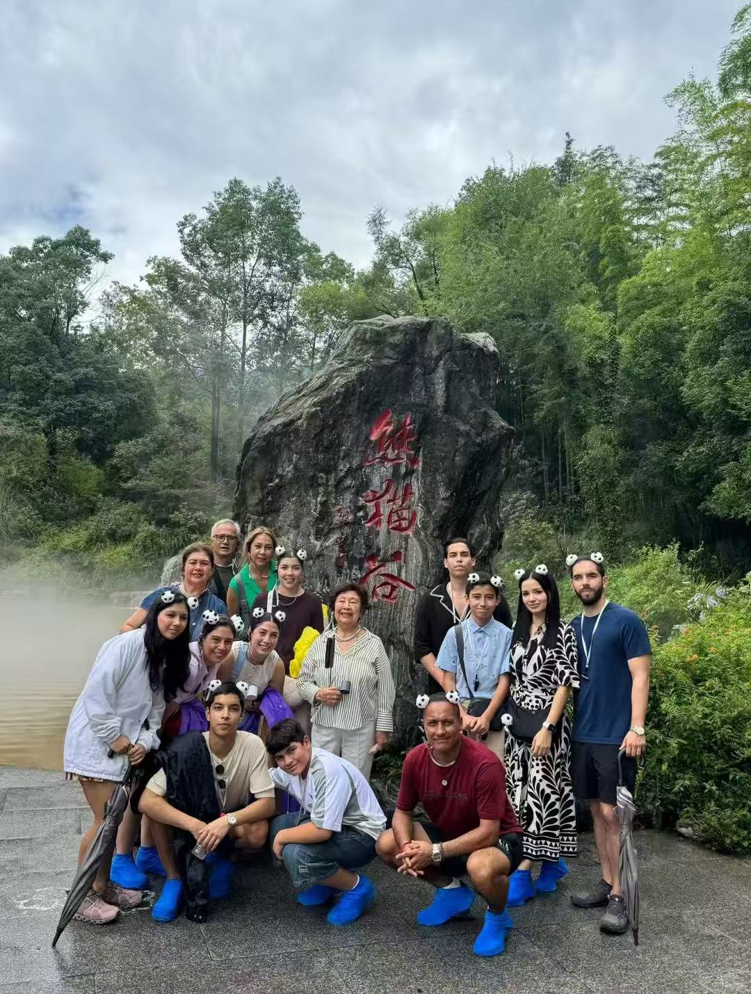 Large tour group wearing panda headbands at Panda Valley, China